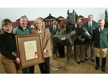 The Spruce Meadows family, pictured in 2003. Pictured from left to right: Linda Heathcott, Ron Southern and Marg Southern hold up their new award for Spruce Meadows while their managers, (centre left to right) Randy Fedorak, Joanne Nimitz, Alan Golby, Ian Allison and Albert Kley stand behind them.