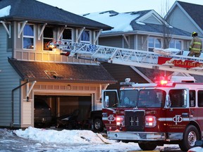 Firefighters clean up after knocking down an early morning fire on Mahogany View S.E. All the residents escaped the blaze that started around 4:30 a.m.