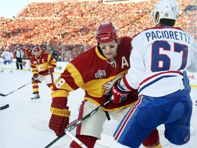 CALGARY, AB: FEBRUARY 20, 2011 - Calgary Flames defenceman Robyn Regehr defends against Montreal Canadiens Mac Pacioretty in the first period of the Heritage Classic at McMahon Stadium, February 20, 2011 in Calgary.      (Dean Bicknell / Calgary Herald) (For Sports section story by Scott Cruickshank) 00029347N