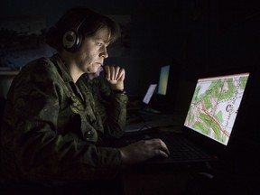Master Corporal Bonnie Critchley participates in virtual training and battle procedure exercises with other Canadian Force colleagues at Metawa Armoury in Calgary.