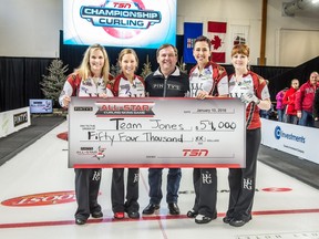 The Jennifer Jones rink poses with their cheque from Pinty's Chief Financial Officer Thane McKenzie on Sunday in Banff.