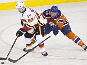 Edmonton's Mark Letestu (55) chases Calgary's Sam Bennett (93) during the third period of the Edmonton Oilers' NHL hockey game against the Calgary Flames at Rexall Place in Edmonton, Alta., on Saturday, Jan. 16, 2016. The Oilers won 2-1.