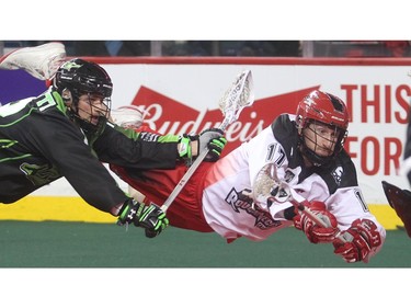 Curtis Dickson of the Calgary Roughnecks lunges for the Saskatchewan Rush net ahead of Adrian Sorichetti Saturday during their home opener Saturday night January 2, 2016 at the Saddledome.