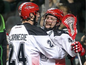 Dane Dobbie, right, celebrates a goal on Saturday night with teammate Scott Carnegie. The Roughnecks lost their National Lacrosse league season opener 10-8 to the Saskatchewan Rush.