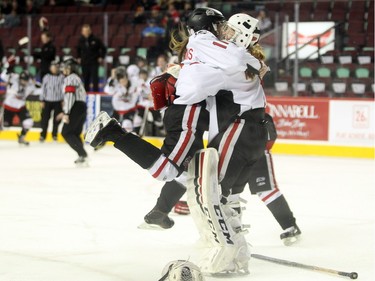 Northern Capitals forward Sage Desjardins, left, jumped into the arms of goalie Kelsey Roberts after their team defeated the Rocky Mountain Raiders during the Mac's AAA Midget female final at the Scotiabank Saddledome on January 1, 2016. The Capitals defeated the Raiders 5-1 to take the 2015 title.