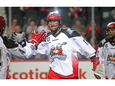 Curtis Dickson of the Calgary Roughnecks slaps hands with Jeff Shattler after scoring against Saskatchewan Rush Saturday January 2, 2015 at the Saddledome during their home opener.