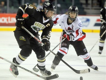 Rocky Mountain Raiders forward Nicolette Seper carried the puck down the ice ahead of Northern Capitals forward Taylor Beck during the Mac's AAA Midget female final at the Scotiabank Saddledome on January 1, 2016. The Capitals defeated the Raiders 5-1 to take the 2015 title.