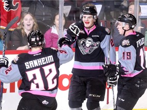 Calgary Hitmen forward Jackson Houck, centre, is eager to play against his old team, the Vancouver Giants, on Friday, while also anticipating the return of teammates Travis Sanheim, left and Radel Fazleev who represented Canada and Russia, respectively, at the World Juniors. The two stars will return to Calgary next week.