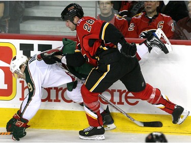 December 29, 2008-  The Calgary Flames' Robyn Regehr squeezes the Minnesota Wild's Mikko Koivu into the boards during third period action.