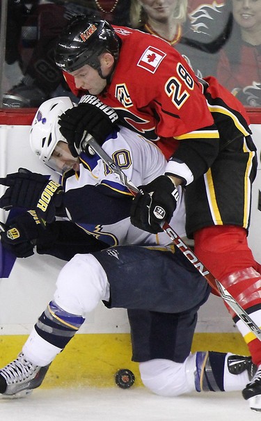 DECEMBER 23, 2009 --  St Louis Blues Andy McDonald collides with Calgary Flames Robyn Regehr