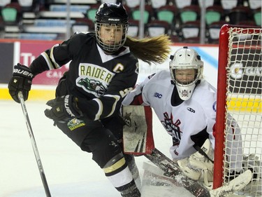 Rocky Mountain Raiders forward Nicolette Seper crashed into Northern Capitals goalie Kelsey Roberts during the Mac's AAA Midget female final at the Scotiabank Saddledome on January 1, 2016. The Capitals defeated the Raiders 5-1 to take the 2015 title.