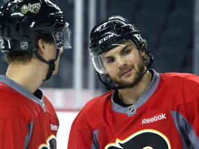 Calgary Flames forward Michael Frolik, right, chats with Mason Raymond during practice at the Scotiabank Saddledome on Tuesday.