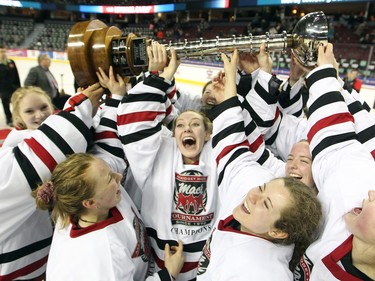 Northern Capitals players including Kenna Lloyd, centre, hoisted the trophy after defeating the Rocky Mountain Raiders in the Mac's AAA Midget female final at the Scotiabank Saddledome on January 1, 2016. The Capitals defeated the Raiders 5-1 to take the 2015 title.