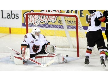 Hitmen goalie Cody Porter keeps an eye on things as the puck slides across in front of the blue line as the Calgary Hitmen played host to the Edmonton Oil Kings on Saturday, January 16, 2016 at the Saddledome.