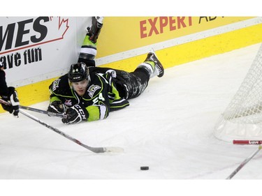 Oil Kings Aaron Irving hit the ice while trying to get control of the puck as the Calgary Hitmen played host to the Edmonton Oil Kings on Saturday, January 16, 2016 at the Saddledome.