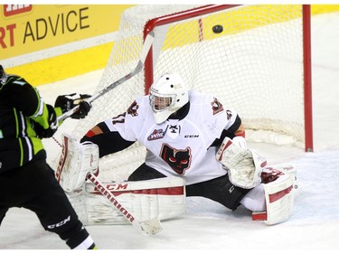 Hitmen goalie Cody Parker looks for the puck as it rings off the post in overtime. The Calgary Hitmen played host to the Edmonton Oil Kings and won 3-2 in overtime on Saturday, January 16, 2016 at the Saddledome.