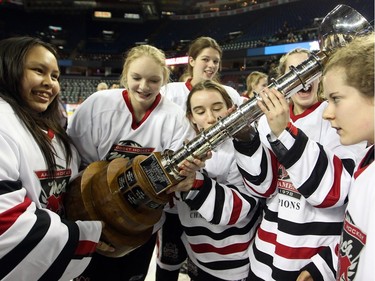 Members of the Northern Capitals celebrated with the trophy after defeating the Rocky Mountain Raiders 5-1 in the Mac's AAA Midget female final at the Scotiabank Saddledome on January 1, 2016.