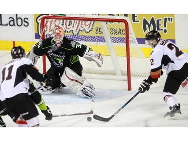 Hitmen Jake Bean, 2, lines up his game winning shot  against goalie Payton Lee, 30, in overtime as the Calgary Hitmen played host to the Edmonton Oil Kings on Saturday, January 16, 2016 at the Saddledome.