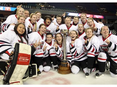 Members of the Northern Capitals celebrated with the trophy after defeating the Rocky Mountain Raiders 5-1 in the Mac's AAA Midget female final at the Scotiabank Saddledome on January 1, 2016.