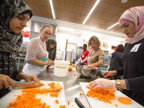 Volunteer Hiba Chakif, right, and her daughters Rana and Mallak prepare soup at Bow Valley College in Calgary on Sunday. Soup Sisters organized the three-day Soup for Syrians event to allow Calgarians to personally get involved with assisting newcomers from Syria.