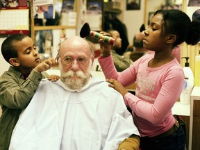 Stan Bevington gets a haircut and polish by Amahayes, left, and Dailia, as part of the Haircuts by Children.