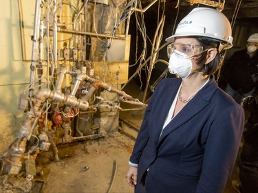 Municipal Affairs minister Danielle Larivee eyes the battered basement of a flood-damaged home on Riverdale Ave SW in Calgary, Alta., on Friday, Jan. 29, 2016. The province showed media around two of the 17 homes purchased by the government after the 2013 flood that are slated for demolition as a lead-up to a community discussion about what to do with the lots once they're vacant. Lyle Aspinall/Postmedia Network