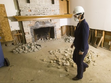 Municipal Affairs minister Danielle Larivee tours a flood-damaged home on Riverdale Ave SW in Calgary, Alta., on Friday, Jan. 29, 2016. The province showed media around two of the 17 homes purchased by the government after the 2013 flood that are slated for demolition as a lead-up to a community discussion about what to do with the lots once they're vacant. Lyle Aspinall/Postmedia Network