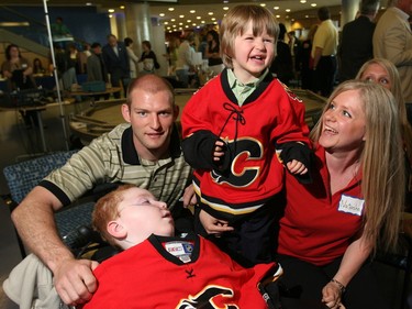 May 9, 20007: Calgary Flames' Robyn Regehr signs jerseys for Cale, 5, and Reid, 3, Tofteland at a press conference with their mom Natasha, announcing a new children's respite/hospice Rotary/Flames House.
