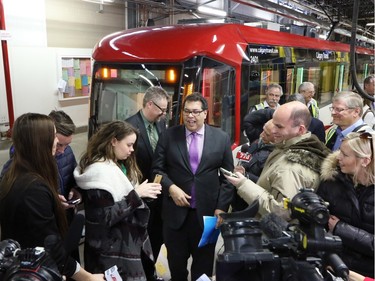 Calgary Mayor Naheed Nenshi talks with media attending the sneak peek of Calgary Transit's new "Mask" S200 CTrain car in Calgary on Friday January 15, 2015.