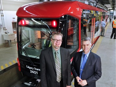 Calgary Transit Director Doug Morgan, left, and the City of Calgary's General Manger of Transportation Mac Logan stand next to one of Calgary Transit's new  "Mask"  S200 CTrain cars  on Friday January 15, 2015.