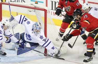 Calgary Flames David Jones , right, tries to score on Toronto maple Leafs netminder James Reimer in NHL hockey action at the Scotiabank Saddledome in Calgary, Alta. on Tuesday February 9, 2016. Leah Hennel/Postmedia