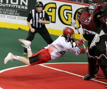 Colorado Mammoth goalie Dillon Ward blocks a shot on net from Calgary Roughnecks Curtis Dickson during game action at the Scotiabank Saddledome in Calgary, Alta. on Saturday February 13, 2016. Leah Hennel/Postmedia