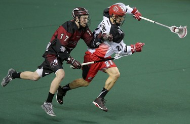 Colorado Mammoth Chris Wardle, left and Calgary Roughnecks Karsen Leung during game action at the Scotiabank Saddledome in Calgary, Alta. on Saturday February 13, 2016. Leah Hennel/Postmedia