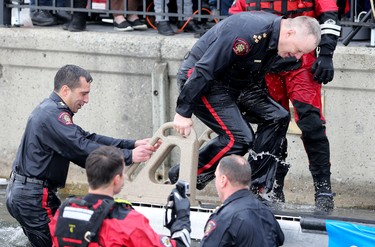 Calgary police chief Roger Chaffin, right, and Deputy Chief Trevor Daroux after jumping into Arbour Lake during Polar Plunge in support for Special Olympics Albarta in Calgary, Ab., on Sunday February 28, 2016. Leah Hennel/Postmedia