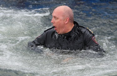 Deputy police chief Paul Cook reacts after jumping in Arbour Lake during  Polar Plunge in support for Special Olympics Albarta in Calgary, Ab., on Sunday February 28, 2016. Leah Hennel/Postmedia