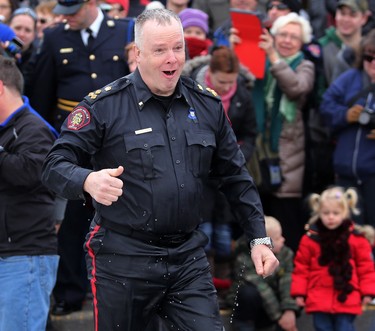 Calgary police chief Roger Chaffin reacts after taking a cold dip in Arbour Lake during Polar Plunge in support for Special Olympics Albarta in Calgary, Ab., on Sunday February 28, 2016. Leah Hennel/Postmedia