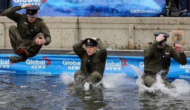 Alberta Fish and Wildlife officers take a cold dip in Arbour Lake during  Polar Plunge in support for Special Olympics Albarta in Calgary, Ab., on Sunday February 28, 2016. Leah Hennel/Postmedia