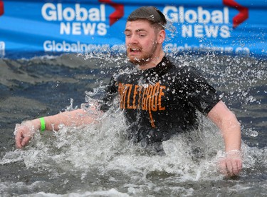 Calgary-Hawkwood MLA Michael Connolly jumps into Arbour Lake during Polar Plunge in support for Special Olympics Albarta in Calgary, Ab., on Sunday February 28, 2016. Leah Hennel/Postmedia