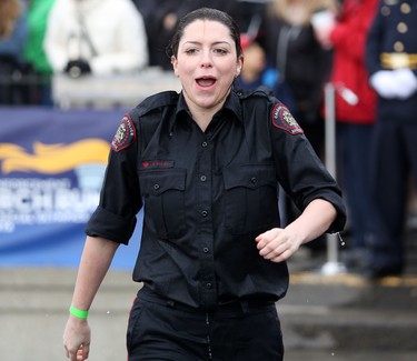 Calgary Police officer Kathleen Bailey reacts after jumping into Arbour Lake during Polar Plunge in support for Special Olympics Albarta in Calgary, Ab., on Sunday February 28, 2016. Leah Hennel/Postmedia