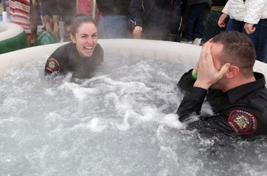 Police warm up after jumping in Arbour Lake during  Polar Plunge in support for Special Olympics Albarta in Calgary, Ab., on Sunday February 28, 2016. Leah Hennel/Postmedia