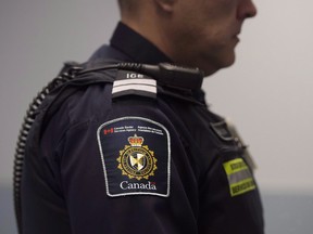 A Canadian Border Services agent stands watch. THE CANADIAN PRESS/Darren Calabrese