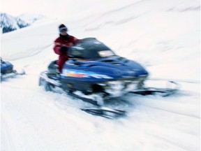 Two people snowmobiling --- Begin Additional Info --- Snowmobile