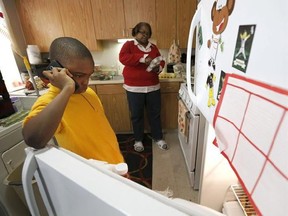 In this Jan. 29, 2016, photo, Debra Aldridge, right, continues to make dinner as her grandson Mario Hendricks talks to a cousin about being able to go to a sleep-over at the cousin&#039;s home, at her home on Chicago&#039;s South Side. Nationwide, there are 2.7 million grandparents raising grandchildren. About a fifth have incomes that fall below the poverty line, according the Census figures. More grandparents are taking on the role of parents for their grandkids, as social service agencies try to place