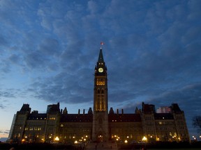 The sun sets behind Parliament Hill in Ottawa on Thursday, November 5, 2015. THE CANADIAN PRESS/Sean Kilpatrick