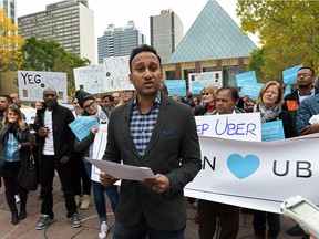 Ramit Kar, GM of Uber Alberta, was flanked by supporters of Uber during a rally outside of City Hall in Edmonton on Wednesday Sept. 16, 2015.