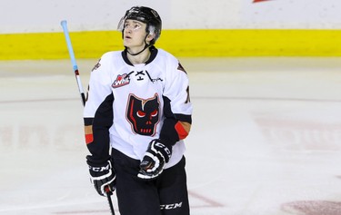 Calgary Hitmen Dawson Martin looks up at the scoreboard after scoring his first goal - which turned out to be the game winner - against Lethbridge Hurricanes goalie Jayden Sittler  in WHL action at the Scotiabank Saddledome in Calgary, Alberta, on Saturday, February 20, 2016. The Hitmen beat the Hurricanes 3-2. Mike Drew/Postmedia