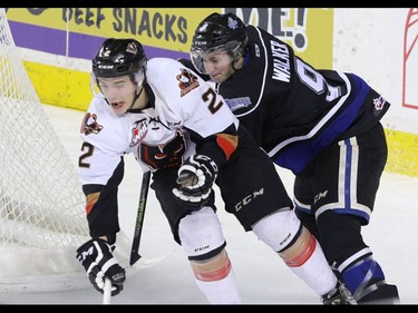 Calgary Hitmen Jake Bean corralled by Victoria Royals Jack Walker in WHL action at the Scotiabank Saddledome in Calgary, Alberta, on Friday, February 26, 2016. Mike Drew/Postmedia