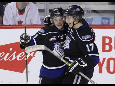 Victoria Royals Matthew Phillips, left, and Tyler Soy celebrate a goal against the Calgary Hitmen in WHL action at the Scotiabank Saddledome in Calgary, Alberta, on Friday, February 26, 2016. Mike Drew/Postmedia