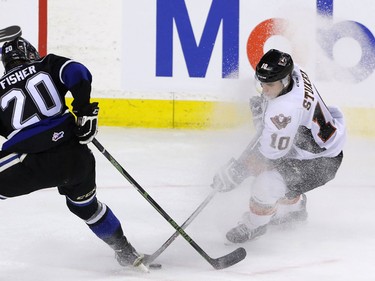Calgary Hitmen Jakob Stukel tries to get around Victoria Royals Logan Fisher in WHL action at the Scotiabank Saddledome in Calgary, Alberta, on Friday, February 26, 2016. The Hitmen lost to the Royals 6-2. Mike Drew/Postmedia