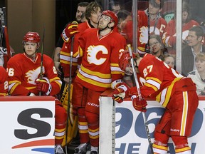 No joy on the Calgary Flames bench as Tyler Wotherspoon, Jakub Nakladal and Dougie Hamilton watch the final minute of the game against the Ottawa Senators wind down in NHL hockey action at the Scotiabank Saddledome in Calgary on Saturday, February 27, 2016. The Flames lost to the Senators 6-4. Mike Drew/Postmedia